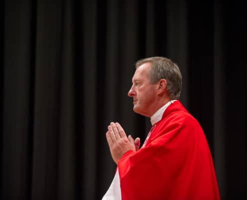 Father Vaillancourt offering up prayer